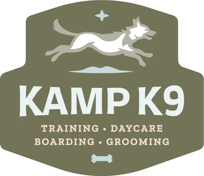 Kamp K9 badge logo with a leaping dog over Training, Daycare, Boarding, Grooming